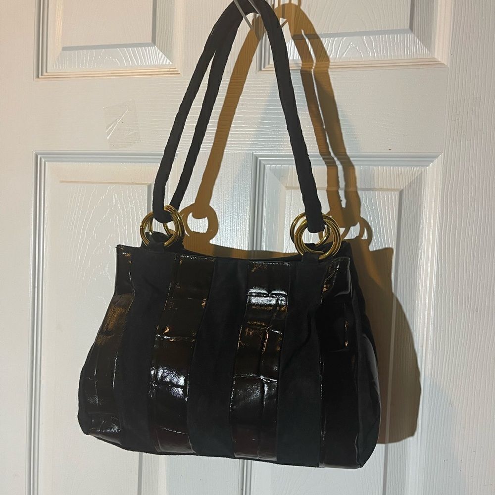 Lacovina leather /suede black medium shoulder Bag with gold tone ring accents .